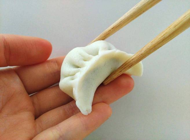 dumpling candy on hand with chopsticks
